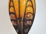 a vase that is sitting on a stand on a white surface