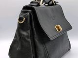a close up of a black purse on a white background