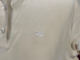 an image of a white polo shirt with a logo on it