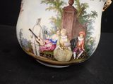 a white pitcher with a painting on it on a table