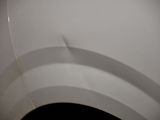 a close up of a car ' s tire with a shadow on the tire