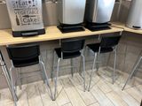 a row of three soda dispensers sitting on a counter