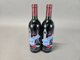 two bottles of wine that are sitting on a table
