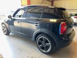 a picture of a black mini cooper parked in a garage