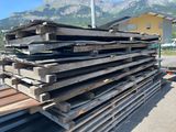 a large pile of wood sitting on the side of the road