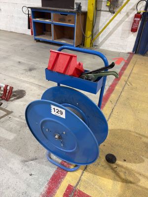 a blue hose on a cart in a garage