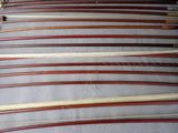 many different types of wooden canes lined up on a table