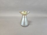 a silver vase with a gold top on a white background
