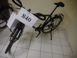a bicycle that is sitting on the floor with a price tag attached to it