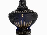 an image of a black and gold urn with a lion on top