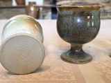 three vases sitting on a table next to each other