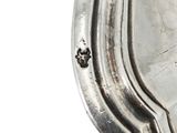 a close up of a silver plate on a white background