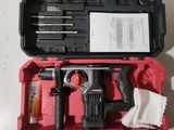 a red tool case with tools in it on a table