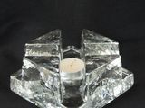 candle holder made of glass blocks with a candle in the middle