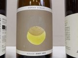 three bottles of wine are lined up on a table