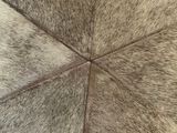 a close up of a cow hide rug on a wooden floor