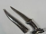 two knives are laying next to each other on a white surface