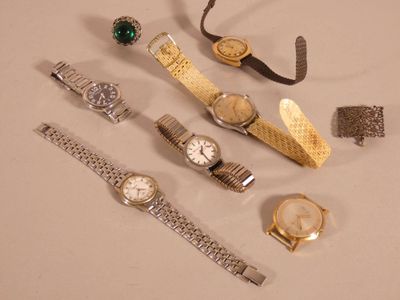 many different types of watches and bracelets on the table