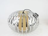 a silver and yellow candle that is sitting on a table