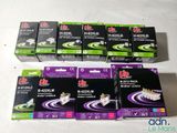 several boxes of toothpaste sitting on top of a white table