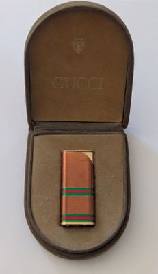 un petit briquet dans un étui posé sur une table