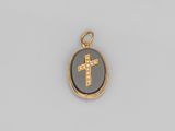 un pendentif en forme de croix en émail doré et noir