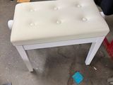 a white bench with buttons on it in the middle of a room