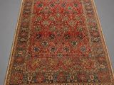 an antique persian rug with red and blue colors