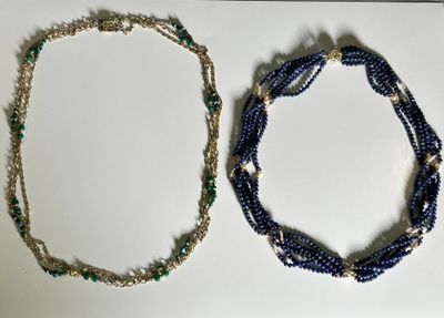 two necklaces that are sitting on a table