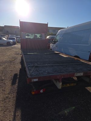 a white van that is sitting in the back of a truck