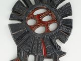a metal sculpture of a windmill on a white surface