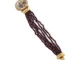 a close up of a wrist watch with a chain around it