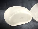 two pieces of frosted glass on a black surface