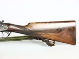 a close up of a rifle on a white background with a green strap