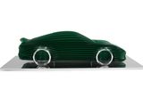an image of a green toy car on a plate