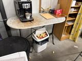 a small table with a coffee maker on it in a garage