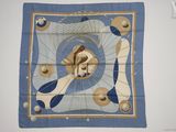 une photo d'un foulard carré bleu et blanc sur lequel figure le portrait d'une femme