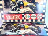 two boxes of scalextric racing cards on a table