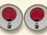 two plates with a red hot air balloon on them