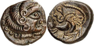 an ancient coin with a head of a lion and a face of a lion