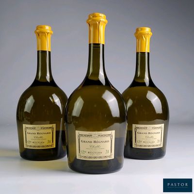 three bottles of wine sitting on top of a table next to each other