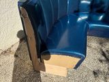 a blue booth with a cardboard box on the ground