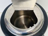 a metal bowl with a metal lid on a table