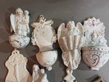 a lot of ceramic figurines on the wall