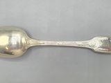 silver spoon on a table with a white background