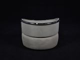 a close up of a white stool on a black background