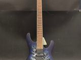 a blue electric guitar with a black and white design on it