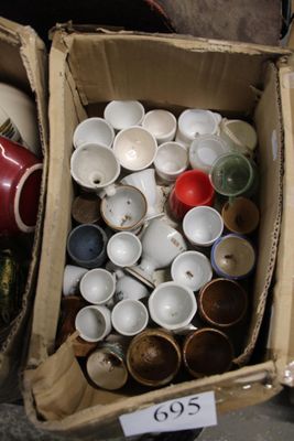 many cups and bowls in a box with a price tag