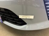a close up of a car ' s grille with a sticker on it
