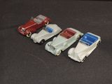 several toy cars are lined up in a row on a black surface